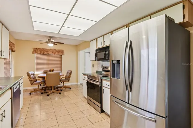 a view of a hardwood floor and windows in a room
