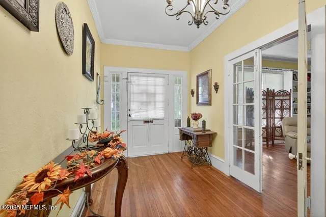 a bedroom with furniture and a wooden floor