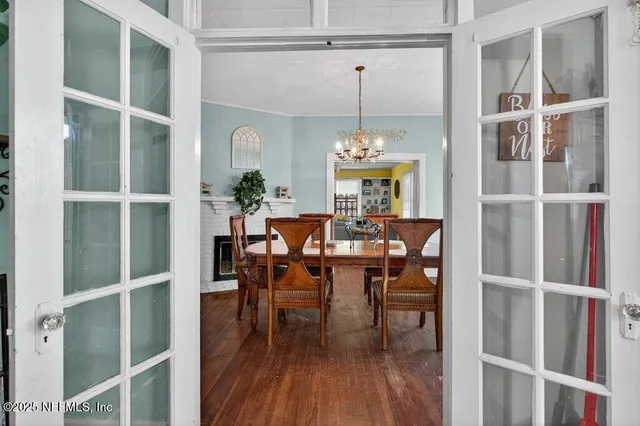 a view of a dining room with furniture wooden floor and chandelier