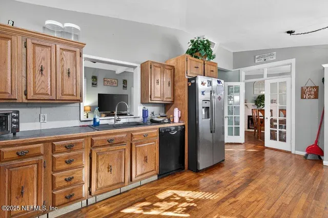 a kitchen with stainless steel appliances granite countertop a refrigerator sink and cabinets