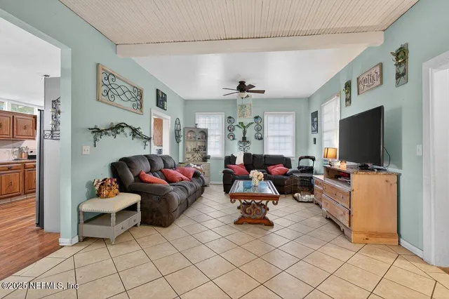 a living room with furniture and a flat screen tv