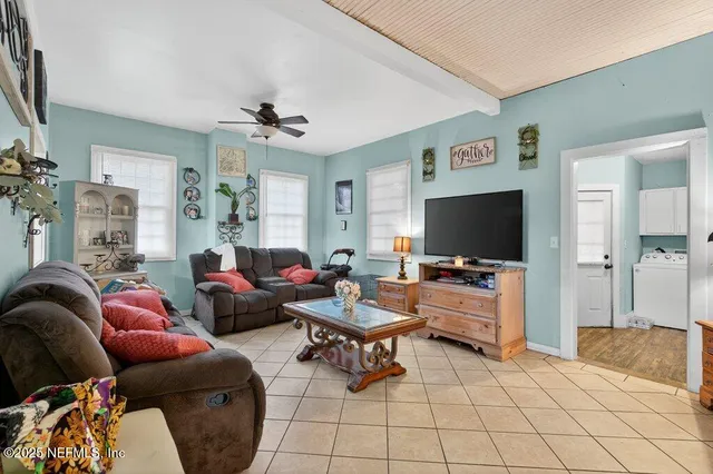 a living room with furniture and a flat screen tv