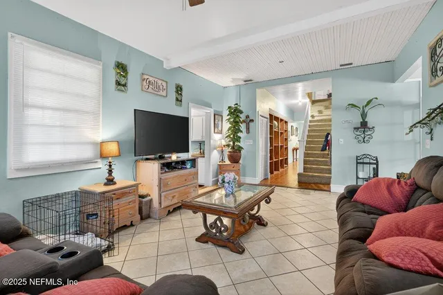 a living room with furniture and a flat screen tv