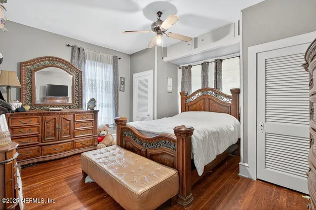 a bedroom with a bed dresser and a window