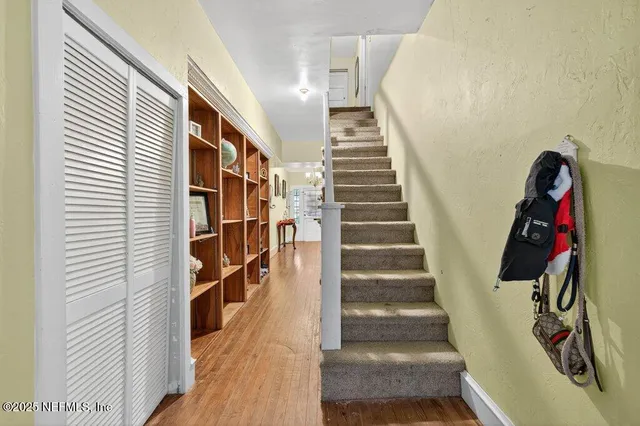 a view of entryway with wooden floor and stairs