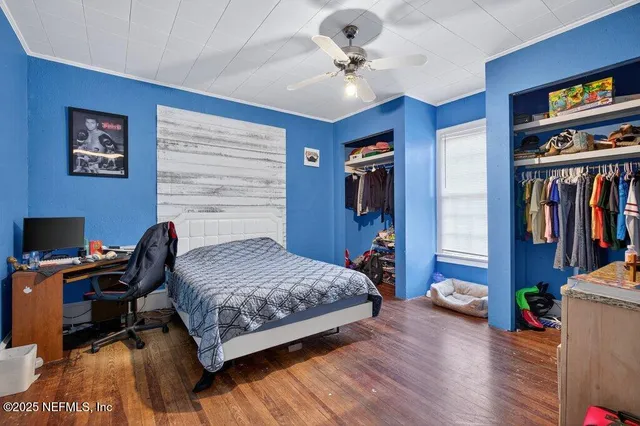 a bedroom with a bed and a book shelf