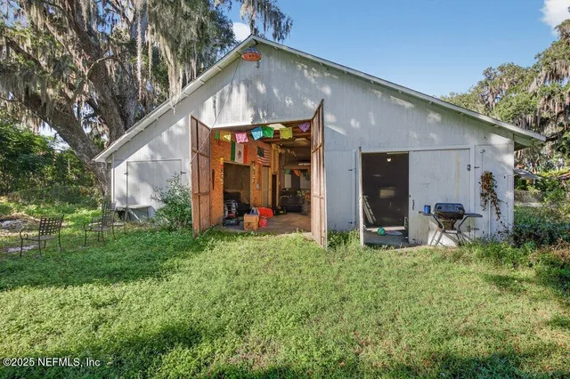 a view of a house with backyard and sitting area