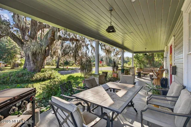 a view of an outdoor dining space with a table and chairs