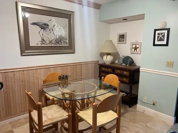 a dining room with furniture and window