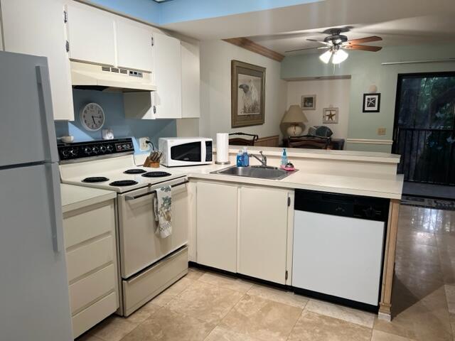 1605 Highway 1, Unit E203 Jupiter, FL 33477 - Photo 13 of 28 a kitchen with cabinets a sink stainless steel appliances and a window