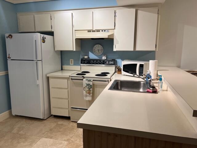 1605 Highway 1, Unit E203 Jupiter, FL 33477 - Photo 14 of 28 a kitchen with a stove a refrigerator and a sink