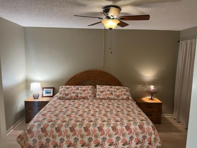 1605 Highway 1, Unit E203 Jupiter, FL 33477 - Photo 16 of 28 a bedroom with a bed and a chandelier