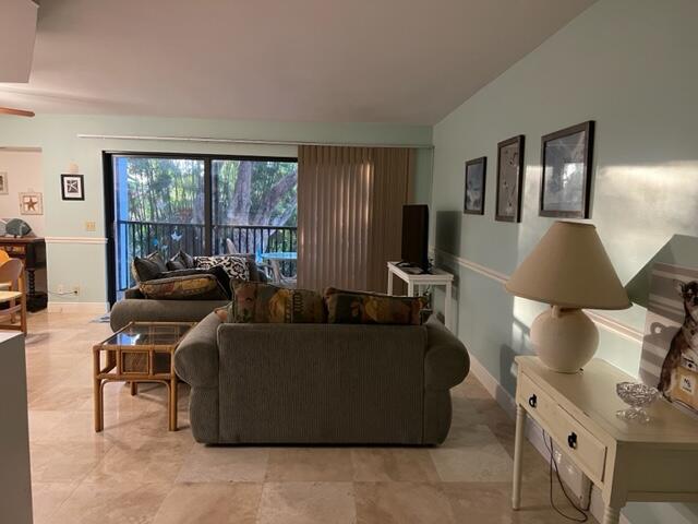 1605 Highway 1, Unit E203 Jupiter, FL 33477 - Photo 5 of 28 a living room with furniture and a lamp
