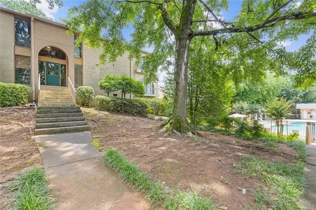 a view of a house with brick walls