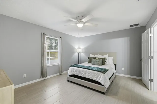 a bedroom with a bed and window