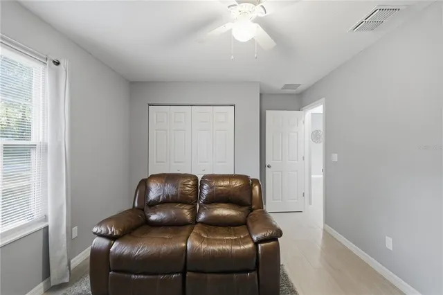 a room with a couch and a fan
