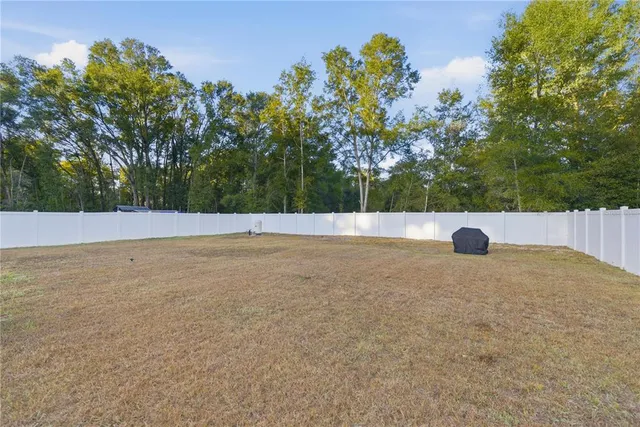 a view of a house with swimming pool and a yard