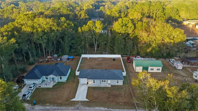 an aerial view of a house with a yard