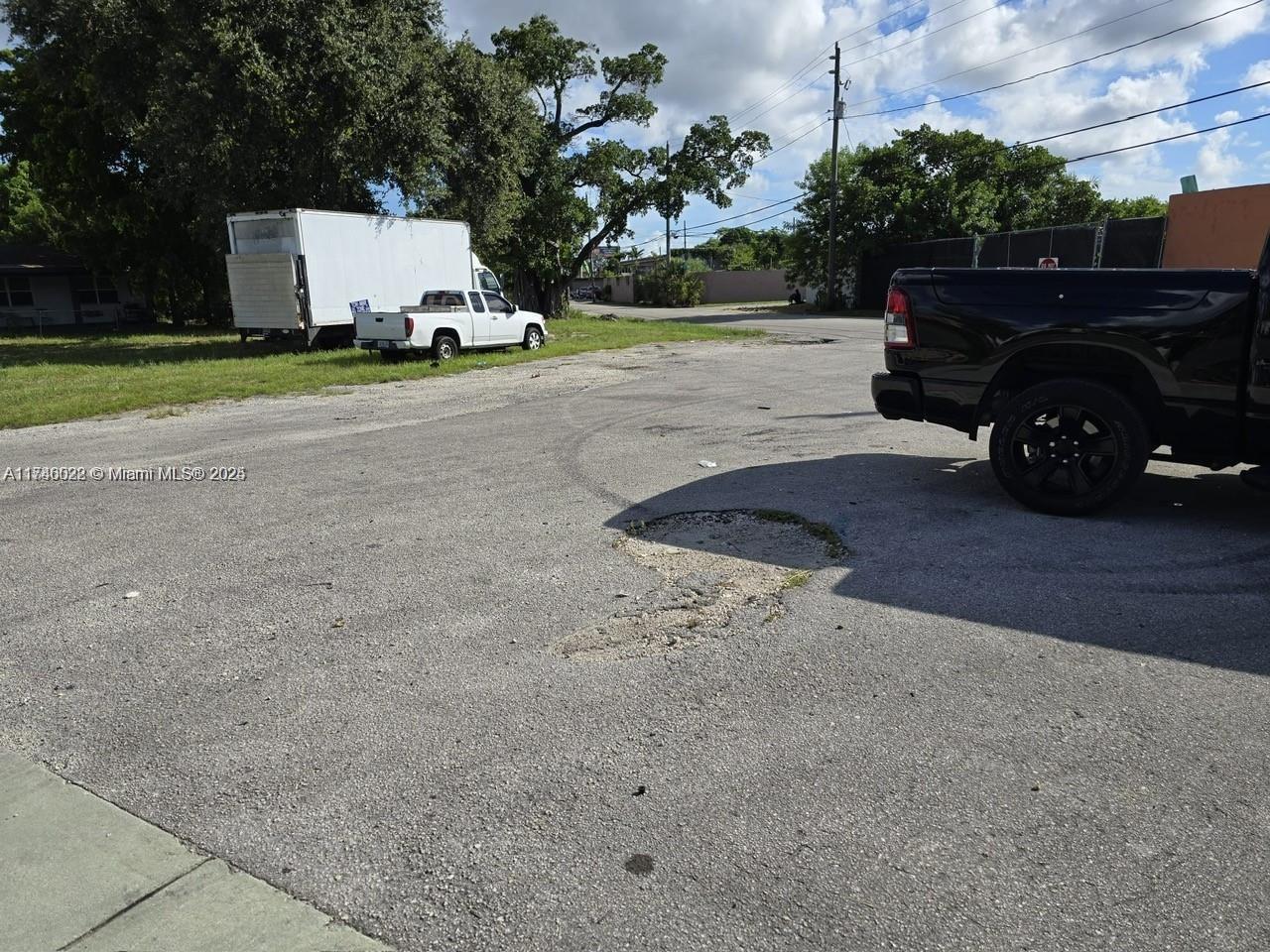 628 Northwest 22nd Road Fort Lauderdale, FL 33311 - Photo 3 of 8 a view of a car parked in back yard of a house