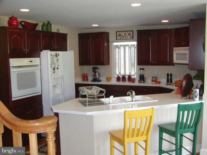 3897 Apple Pie Ridge Road Winchester, VA 22603 - Photo 5 of 10 a kitchen with stainless steel appliances granite countertop a sink stove and refrigerator