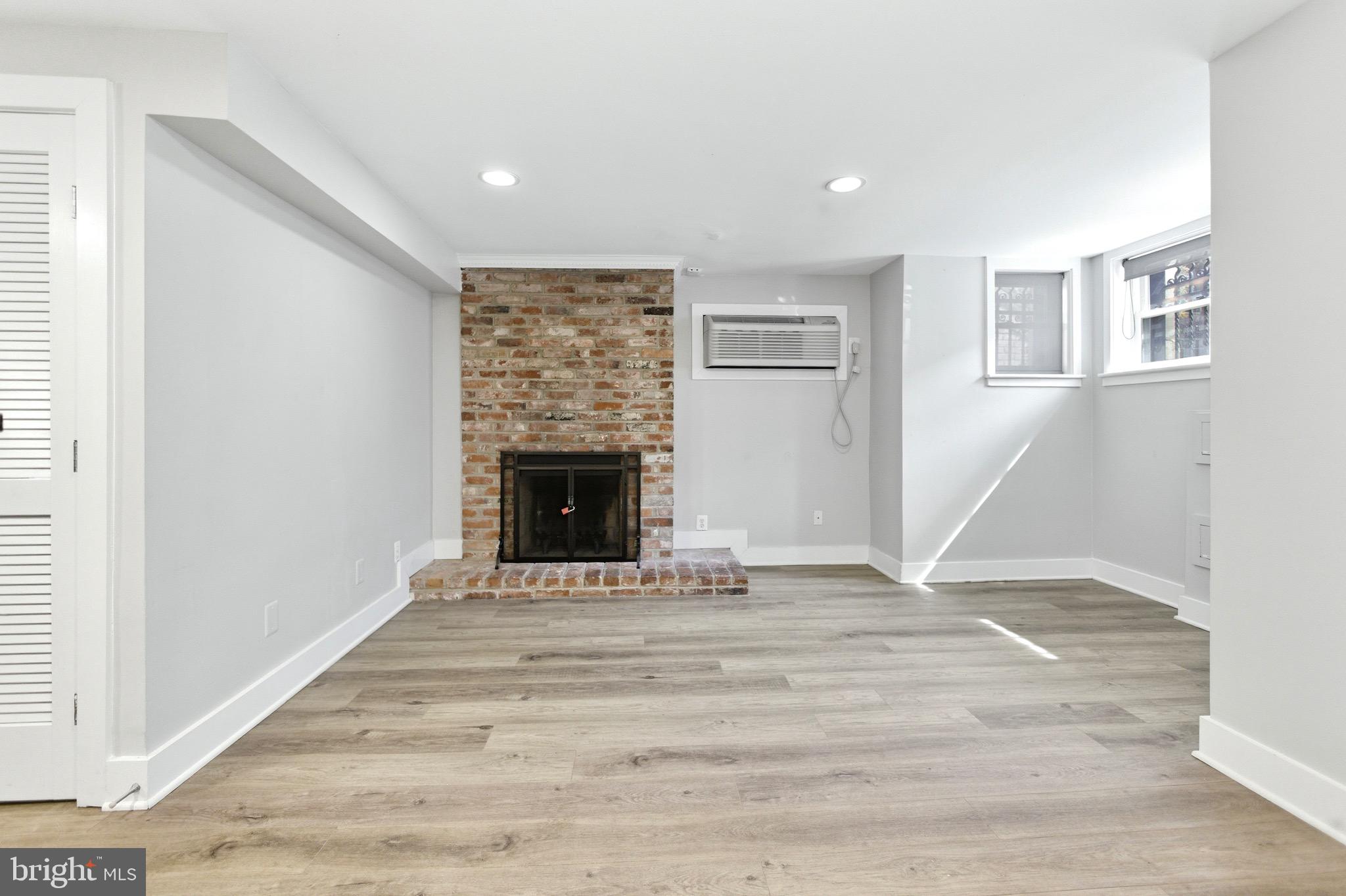 1451 Harvard Street Northwest, Unit 1 Washington, DC 20009 - Photo 14 of 24 a view of an empty room with wooden floor and a window