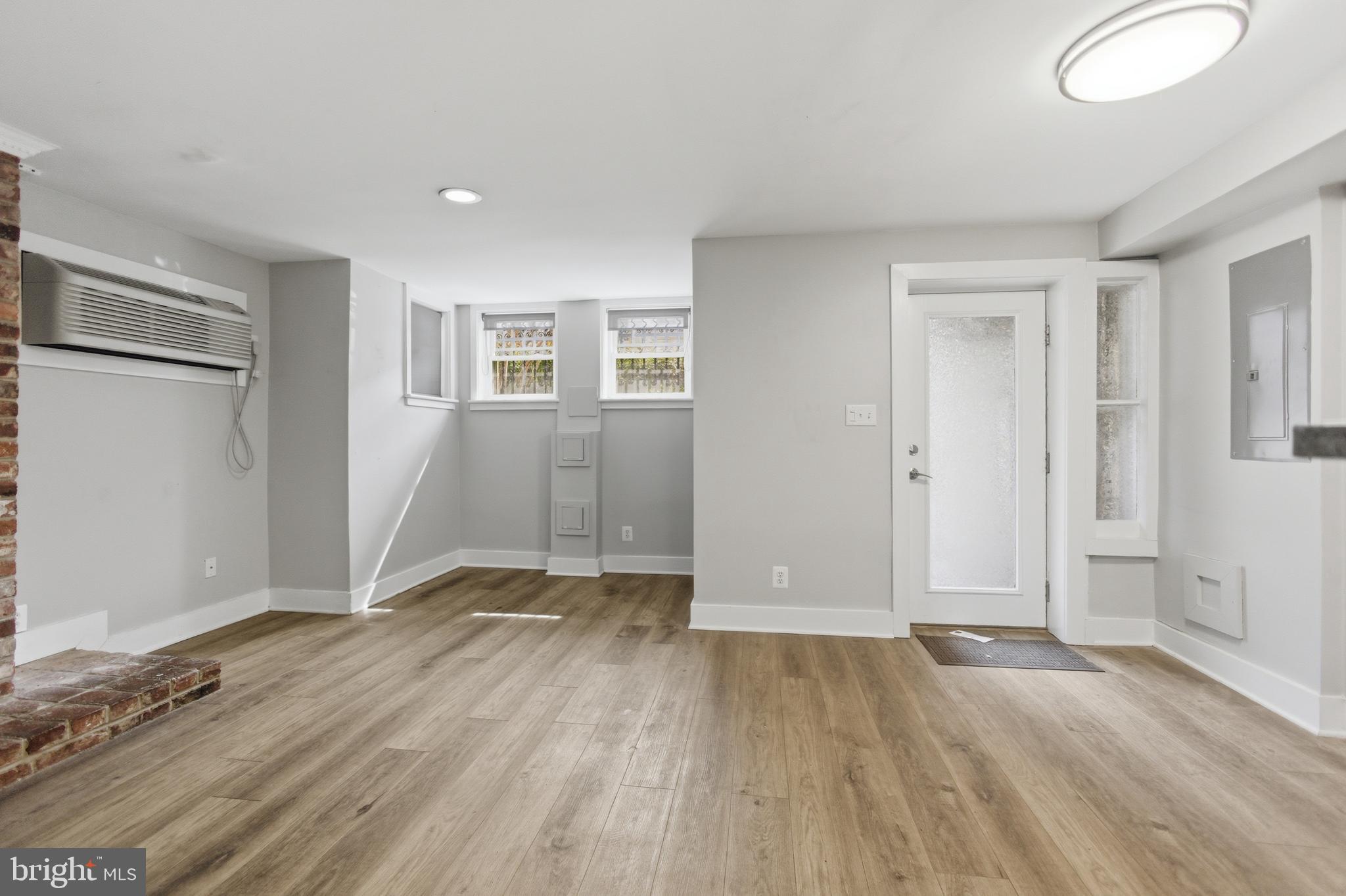 1451 Harvard Street Northwest, Unit 1 Washington, DC 20009 - Photo 17 of 24 an empty room with wooden floor and windows