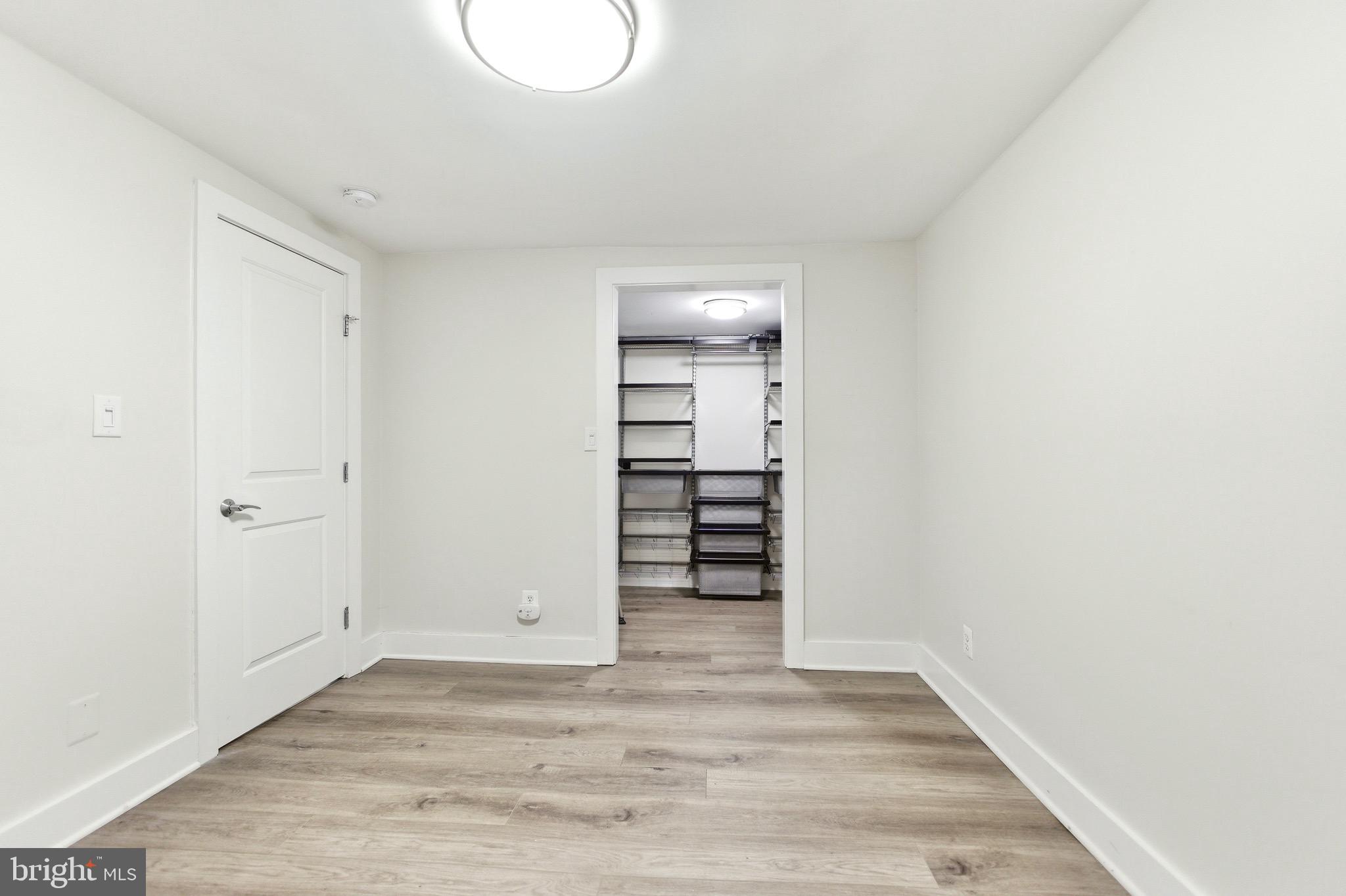 1451 Harvard Street Northwest, Unit 1 Washington, DC 20009 - Photo 18 of 24 a view of a room with wooden floor and closet