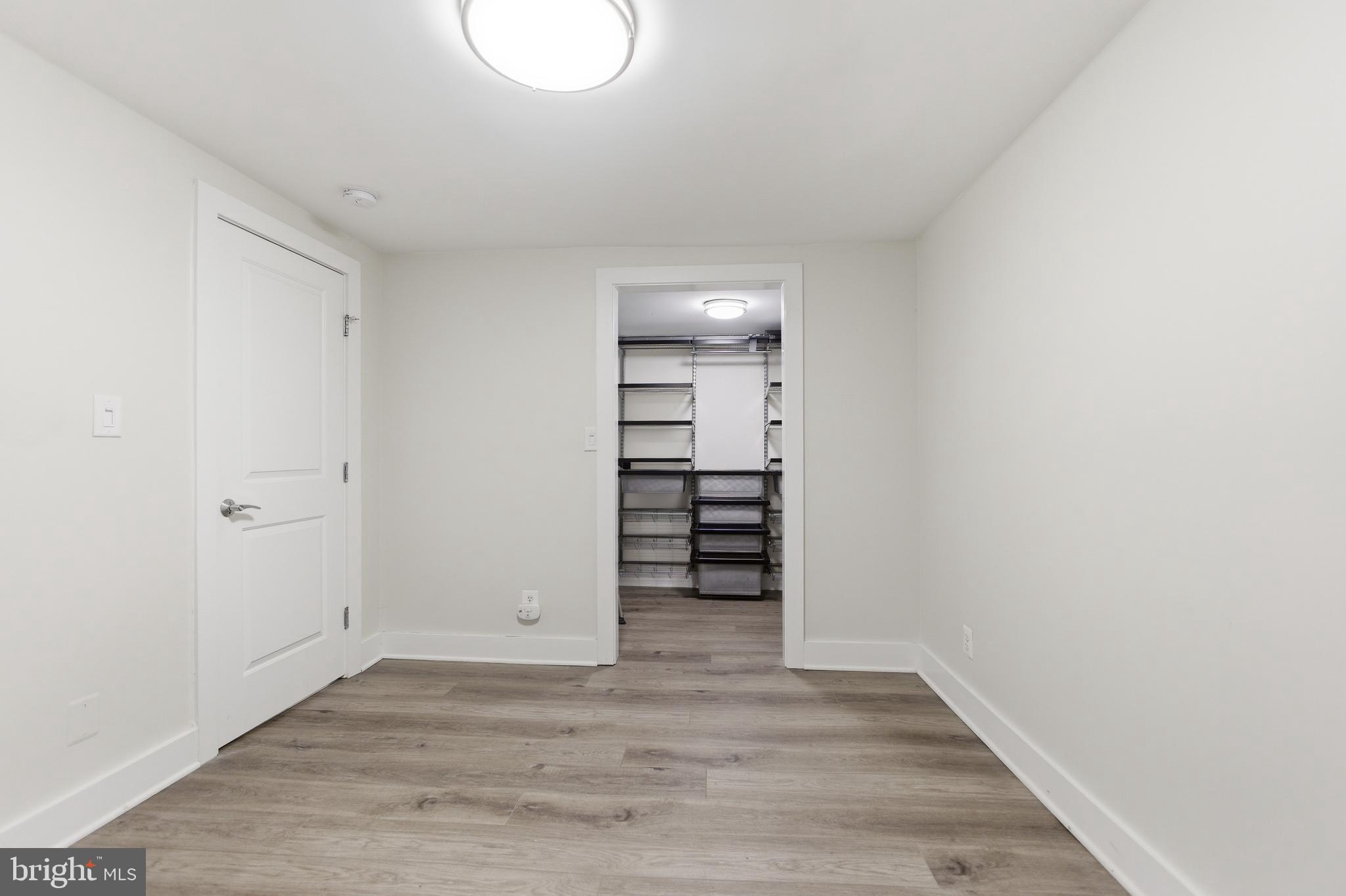 1451 Harvard Street Northwest, Unit 1 Washington, DC 20009 - Photo 21 of 24 a view of a room with wooden floor and closet