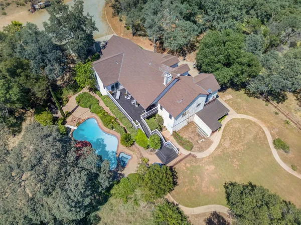 an aerial view of a house with a swimming pool