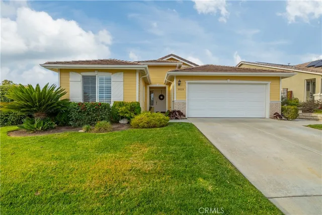 a front view of house with yard and green space