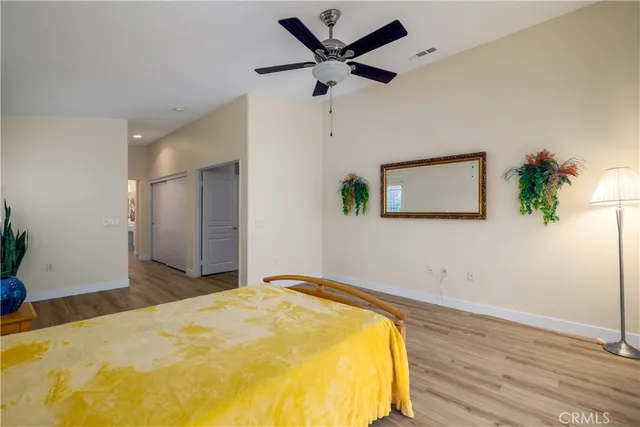 a bedroom with a bed and a potted plant
