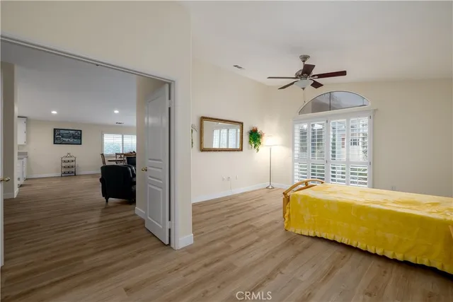a view of a bedroom with wooden floor and furniture