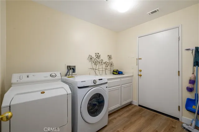 a view of a house with a yard and potted plants