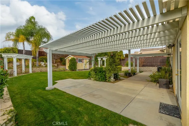 a view of a house with a large window and potted plants
