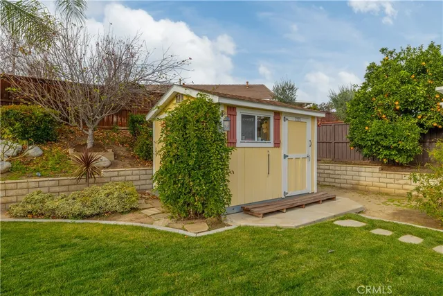 a view of front of house with a yard and potted plants