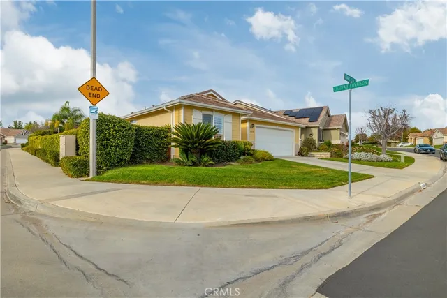 an aerial view of a house with a yard and lake view