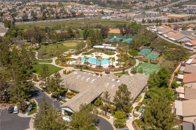 an aerial view of a house with a swimming pool patio and outdoor seating