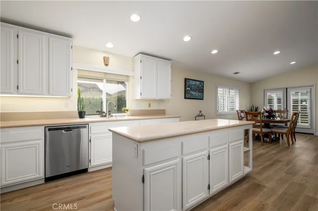 a kitchen with sink cabinets and wooden floor