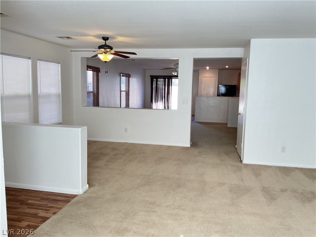 8108 Roundup Ridge Street Las Vegas, NV 89131 - Photo 9 of 21 A versatile interior space featuring mixed flooring and a bright, inviting atmosphere.