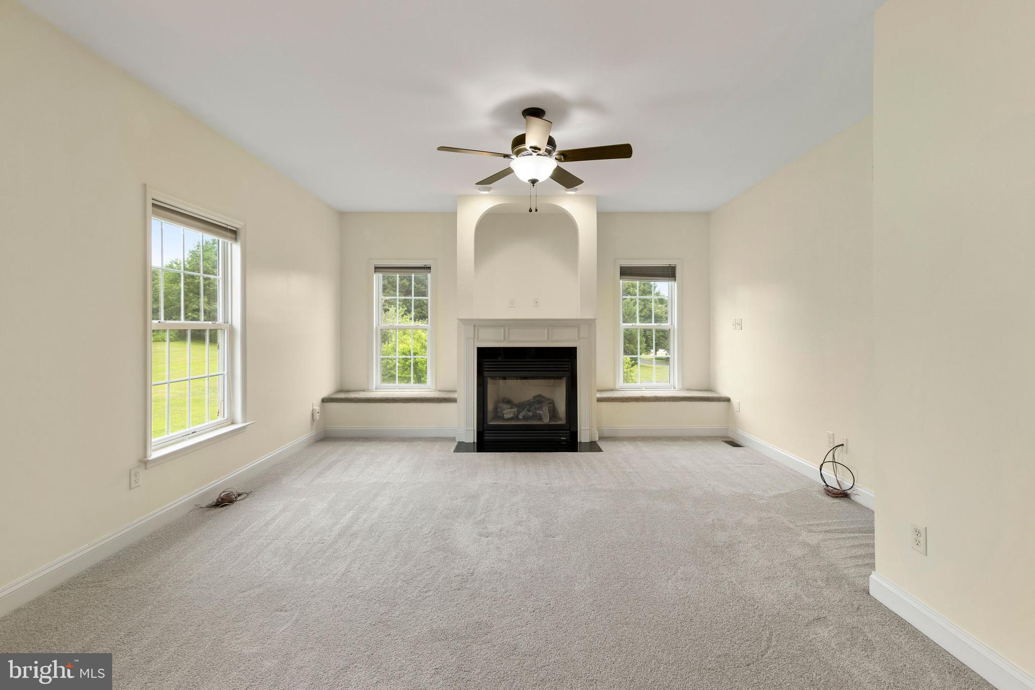 67 Merry Knoll Court Conowingo, MD 21918 - Photo 12 of 50 an empty room with windows and fireplace