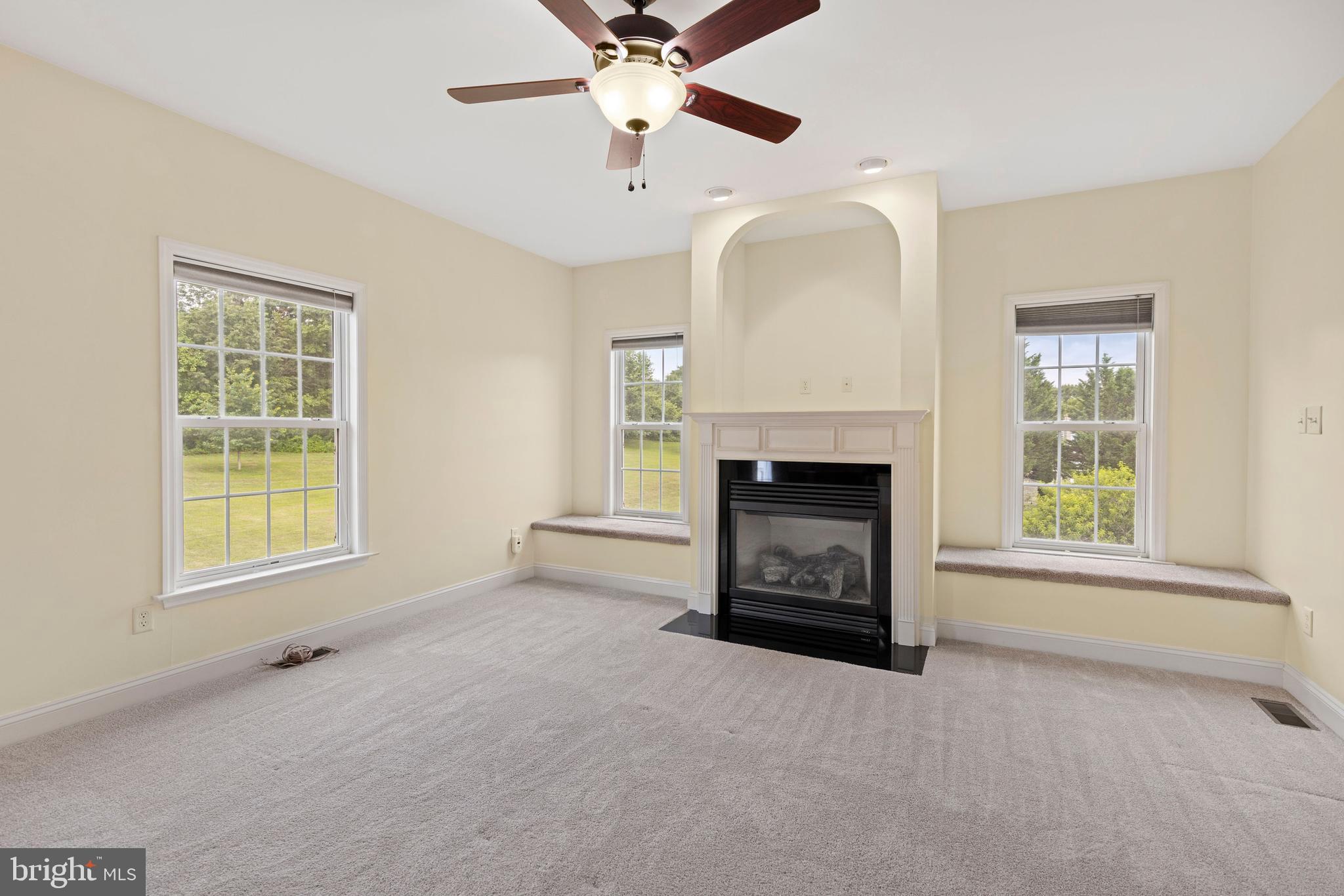 67 Merry Knoll Court Conowingo, MD 21918 - Photo 14 of 50 an empty room with windows and fireplace