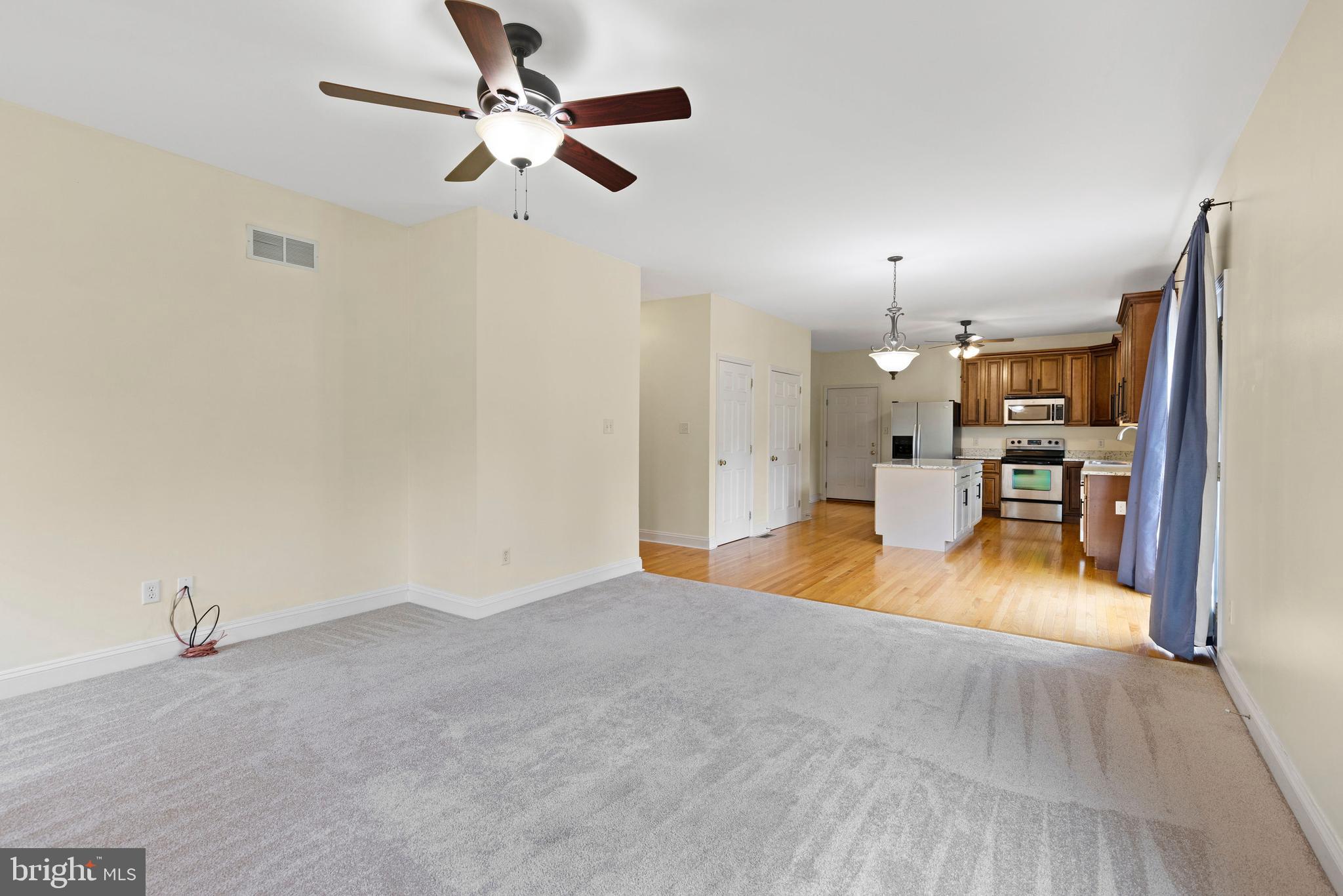67 Merry Knoll Court Conowingo, MD 21918 - Photo 16 of 50 a view of a livingroom with a chandelier fan and kitchen view