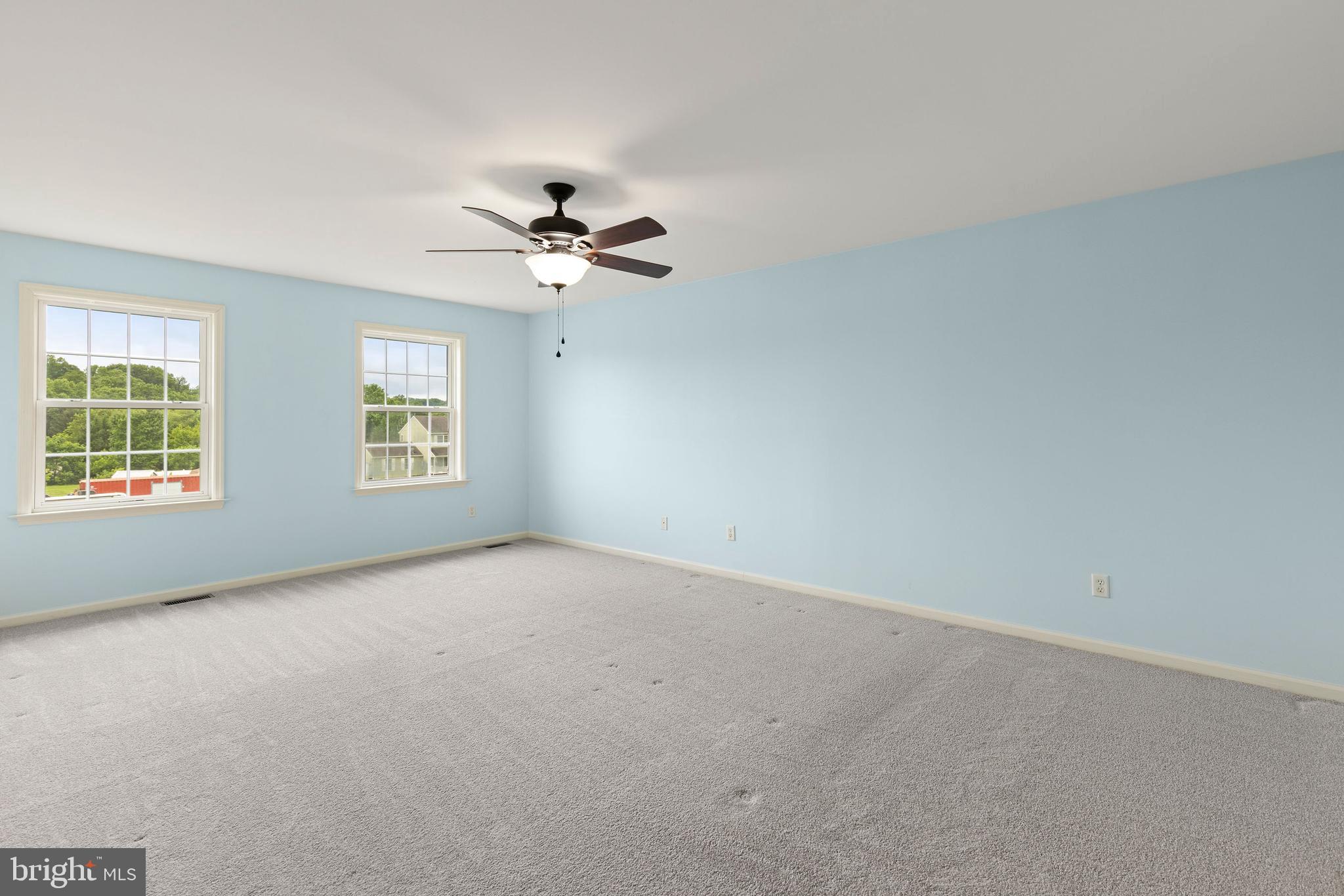67 Merry Knoll Court Conowingo, MD 21918 - Photo 18 of 50 an empty room with windows and chandelier fan