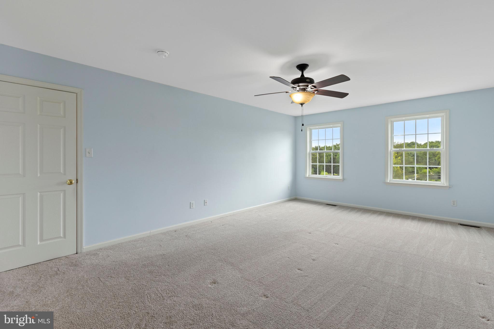 67 Merry Knoll Court Conowingo, MD 21918 - Photo 19 of 50 an empty room with windows and chandelier fan