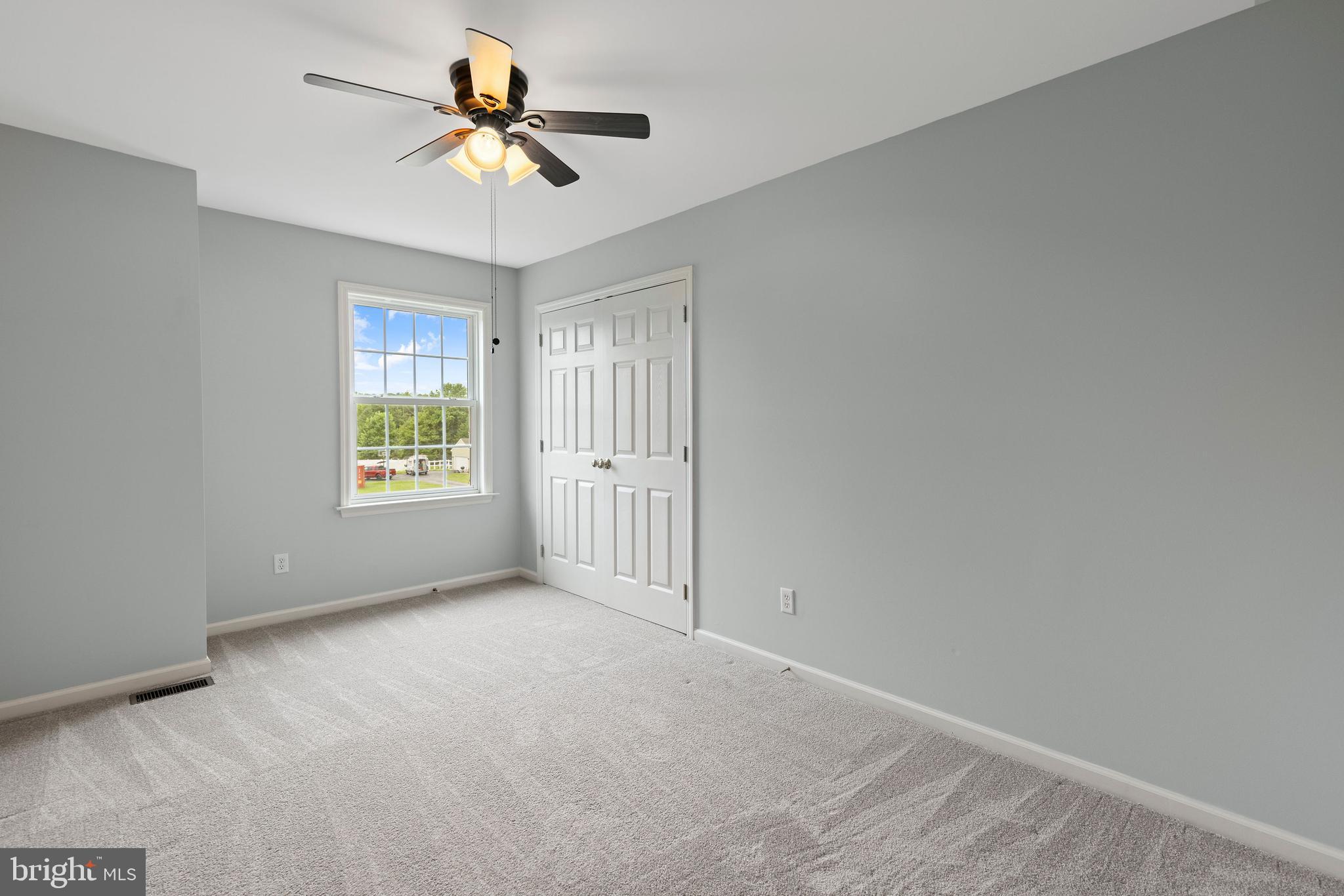 67 Merry Knoll Court Conowingo, MD 21918 - Photo 25 of 50 an empty room with windows and chandelier fan