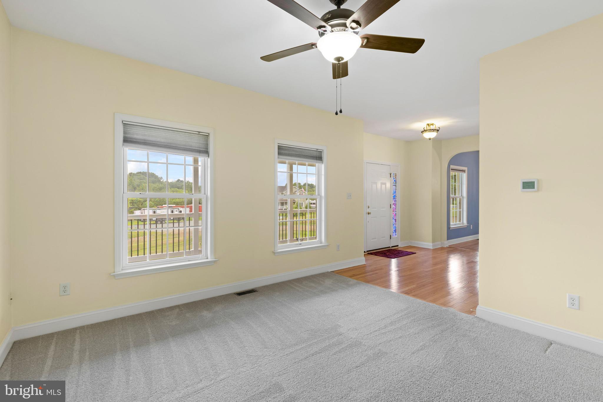 67 Merry Knoll Court Conowingo, MD 21918 - Photo 4 of 50 an empty room with chandelier fan and windows