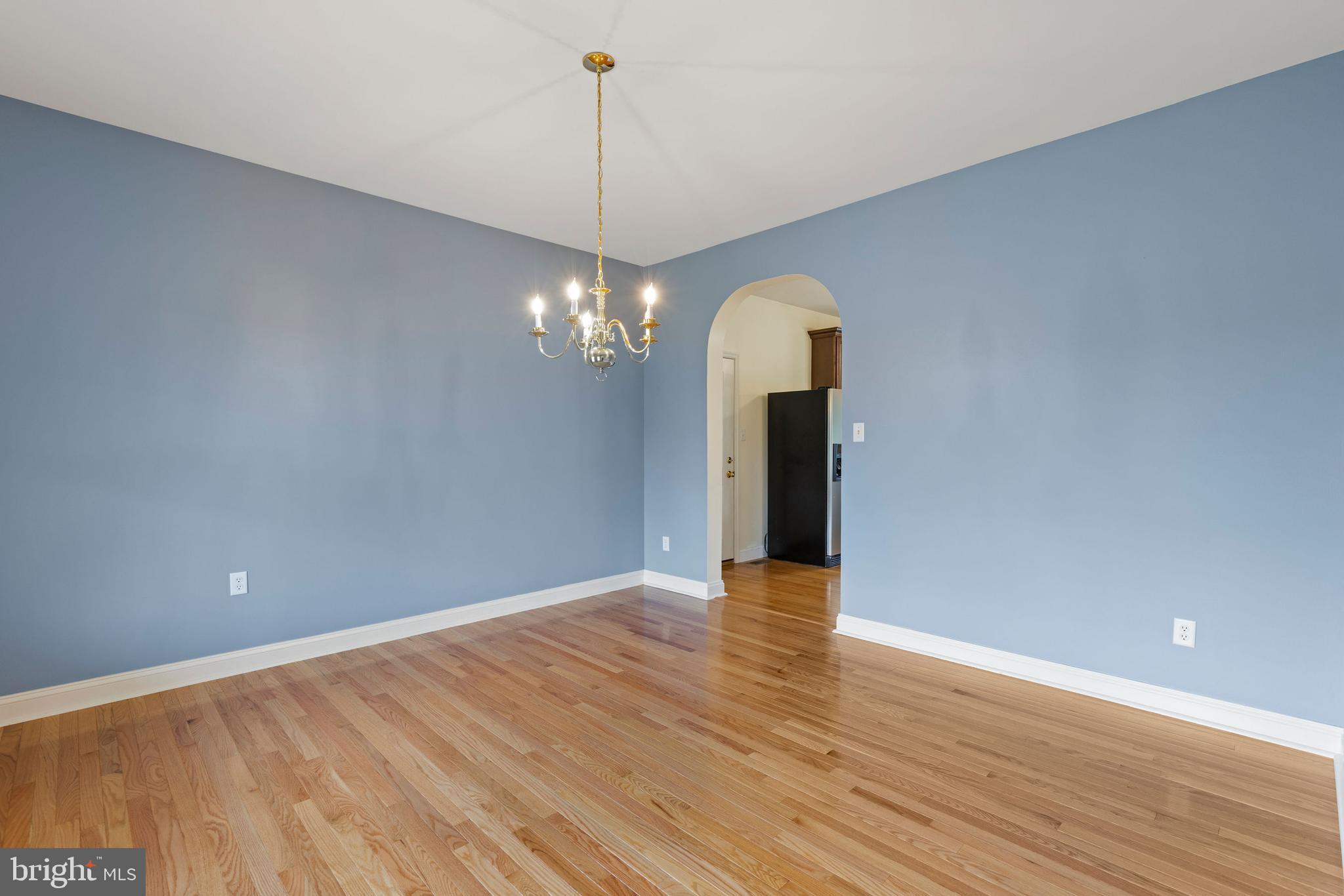 67 Merry Knoll Court Conowingo, MD 21918 - Photo 5 of 50 a view of an empty room with chandelier and wooden floor