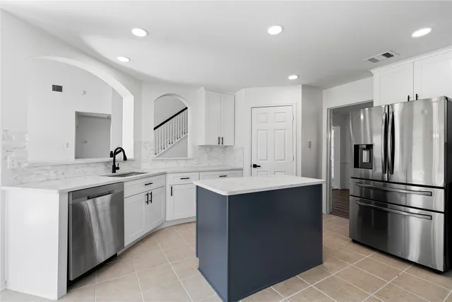a kitchen with a sink stainless steel appliances and cabinets