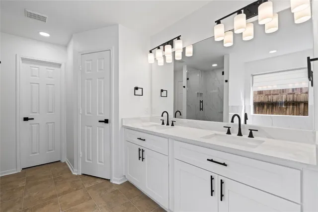 a bathroom with a double vanity sink mirror and double