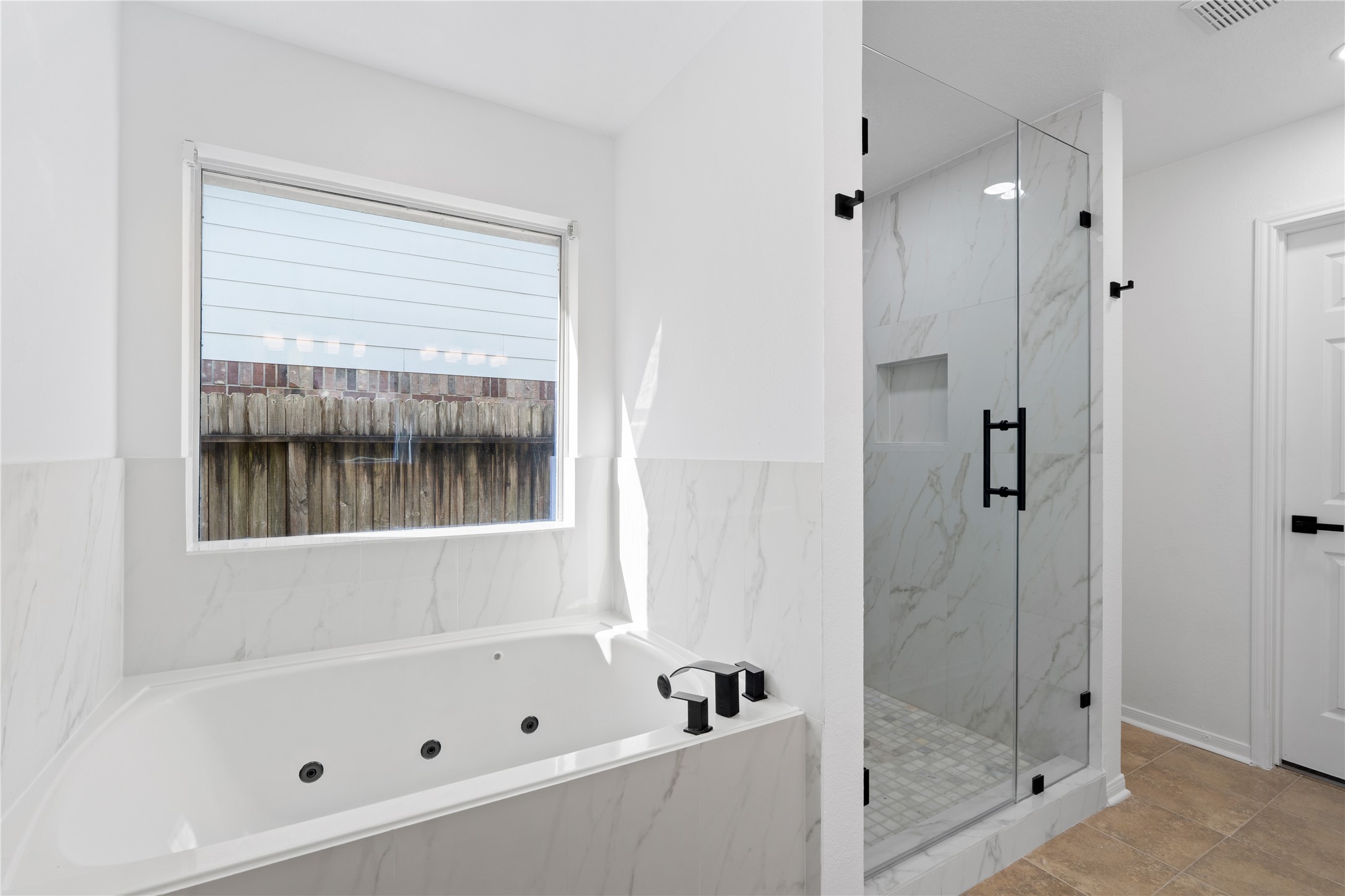 434 Pinewood Ridge Drive Spring, TX 77386 - Photo 20 of 32 a bathroom with a bathtub and a shower